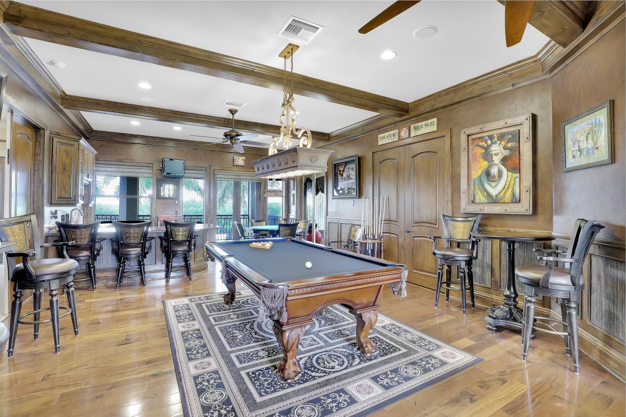 The huge loft has a pool table, card table and bar area and just off the loft is a movie theater.