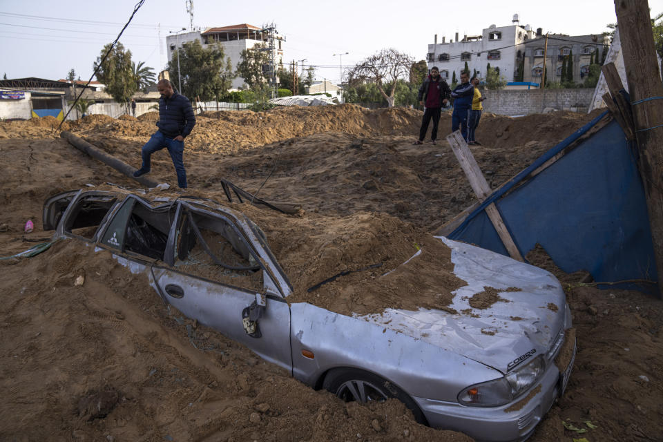 Palestinians inspect damage from overnight Israeli airstrikes in Gaza City, Friday, April 7, 2023. The Israeli military has struck targets in the Gaza Strip, pushing the region toward a wider conflagration after a day of rocket fire along the country's northern and southern borders. The fighting follows two days of unrest at Jerusalem's most sensitive holy site. As Israeli aircraft began striking Gaza, Palestinian militants quickly fired off a new barrage of rockets, setting off air raid sirens across southern Israel. (AP Photo/Fatima Shbair)