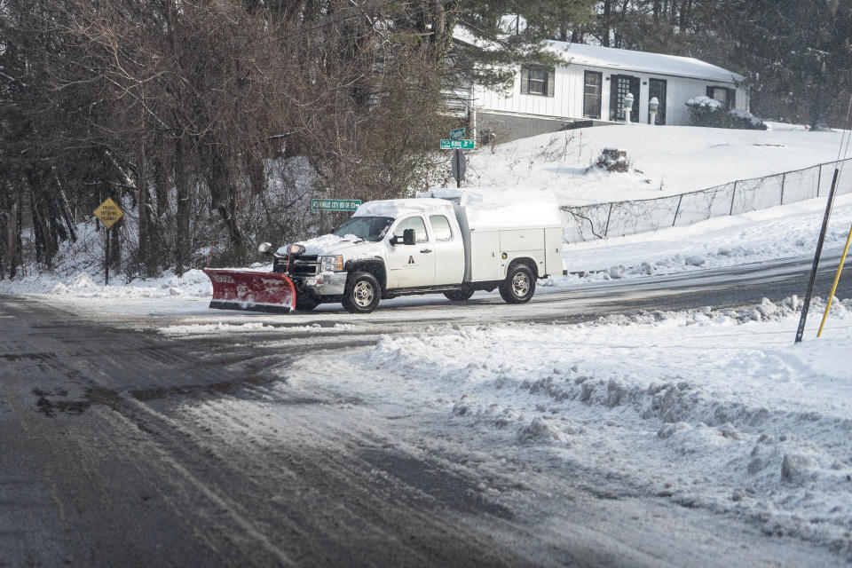 Snow plows plow the roads of downtown Asheville on January 17, 2022.