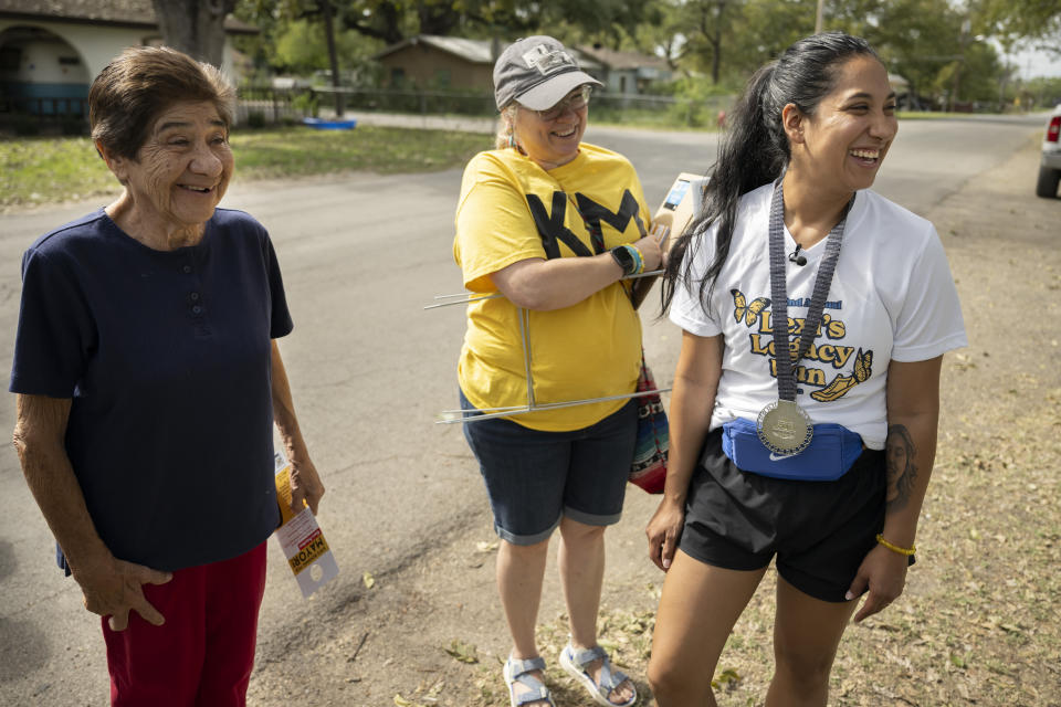 FILE - Uvalde mayoral candidate Kimberly Mata-Rubio, right, speaks with Uvalde resident Antonia Rios, left, alongside campaign manager Dr. Laura Barberena, Saturday, Oct. 21, 2023, in Uvalde, Texas. Mata-Rubio, whose 10-year-old daughter was killed in the Robb Elementary School shooting, lost her run for mayor, Tuesday, Nov. 7. (AP Photo/Darren Abate, File)