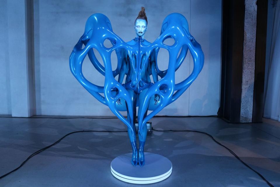 a blue sculpture of a person