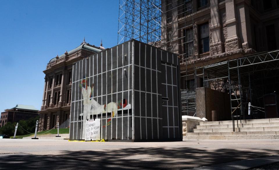 A mock prison stands near the Capitol on Tuesday as part of a campaign by Texas Prisons Community Advocates to raise awareness about the lack of air conditioning in Texas prisons.