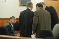 Former New England Patriots football player Aaron Hernandez (L) listens as his attorneys confer during a hearing without the jury present in Hernandez' trial at Bristol County Superior Court in Fall River, Massachusetts April 1, 2015. Hernandez, 25, had a $41 million contract with the National Football League team but was dropped hours after his arrest in June, 2013 on murder and firearms charges in the death of Lloyd, who had been dating his fiancée's sister. Hernandez, who has pleaded not guilty, faces life in prison if convicted. REUTERS/Brian Snyder