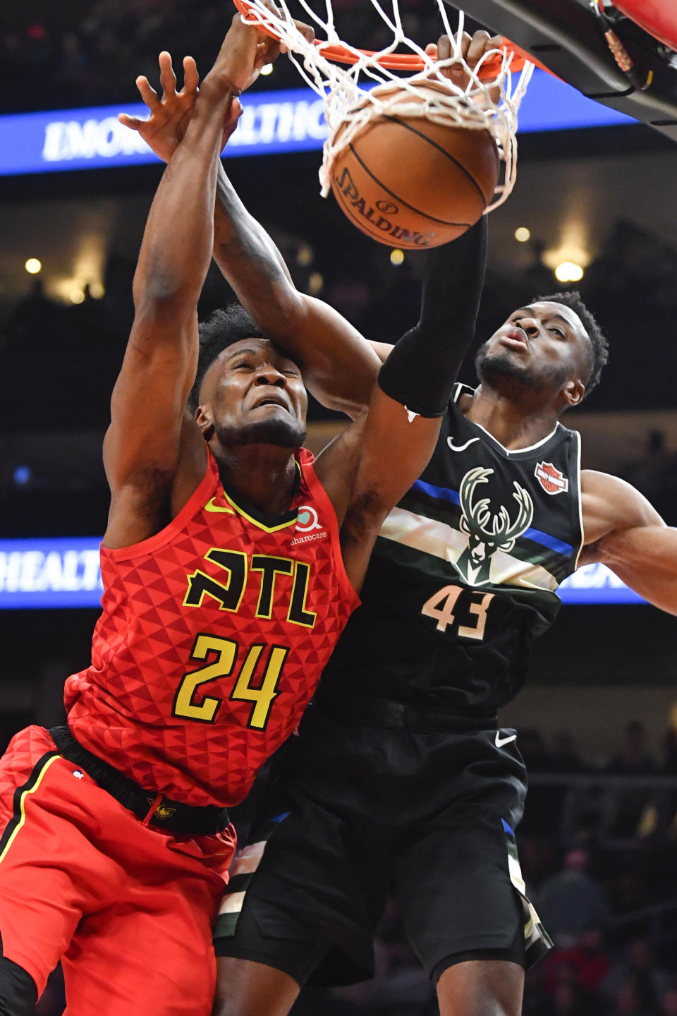 Atlanta Hawks forward Bruno Fernando (24) dunks as Milwaukee Bucks forward Thanasis Antetokounmpo defends during the second half of an NBA basketball game Friday, Dec. 27, 2019, in Atlanta. (AP Photo/John Amis)