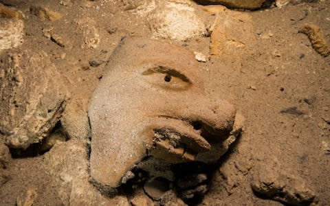 This mask of the Mayan god of trade is just one of the artefacts uncovered at the huge underwater Sac Actun cave in Quinta Roo state, Mexico - Credit: HO/AFP