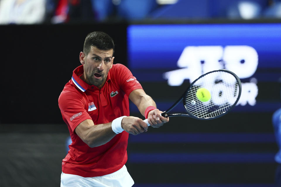 Novak Djokovic of Serbia plays a shot to Zhizhen Zhang of China during the United Cup tennis tournament in Perth, Australia, Sunday, Dec. 31, 2023. (AP Photo/Trevor Collens)