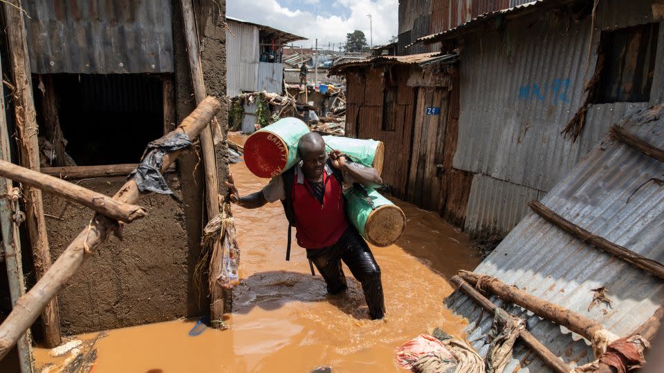 A resident of Mathare slum in Nairobi trying to salvage possessions following deadly flooding in the capital on April 24. - Simon Maina/AFP via Getty Images