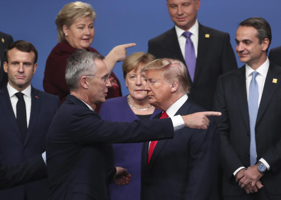 FILE - NATO Secretary General Jens Stoltenberg, center front left, speaks with U.S. President Donald Trump, center front right, after a group photo at a NATO leaders meeting at The Grove hotel and resort in Watford, Hertfordshire, England, Wednesday, Dec. 4, 2019. NATO is desperate to demonstrate that it can stay the course, even as uncertainty over elections roils many of its biggest members. The possible return of Donald Trump, who damaged trust between allies while he was the U.S. president, is of most obvious concern. (AP Photo/Francisco Seco, File)