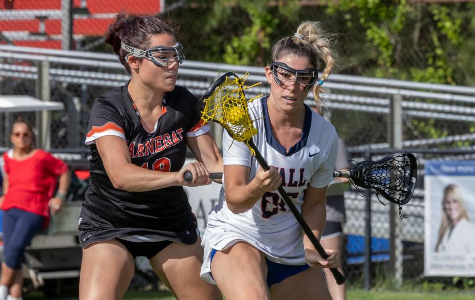 Wall Sophia DeSibio tries to move the ball under heavy coverage. Wall defeats Barnegat 13-8 in NJSIAA Girls Lacrosse in Wall, NJ on May 20, 2022. 