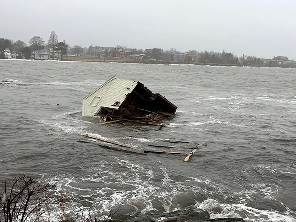 A fishing shack floats away into Casco Bay during a storm in South Portland, Maine (AP)