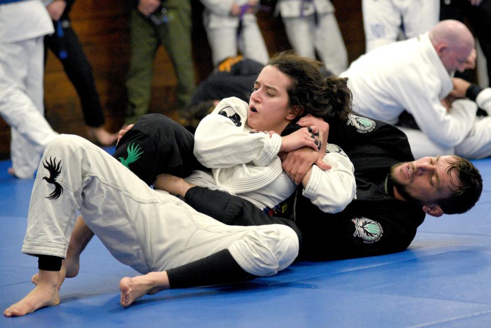 Valencia Vitale, 27, left, attempts to escape from the hold of Chris Ulbricht, 32, on Wednesday, June 7, 2023 at the Garden State Brazilian Jiu-Jitsu Academy in Middletown, New Jersey. Vitale is the program director of the gym and Ulbricht is the owner. 