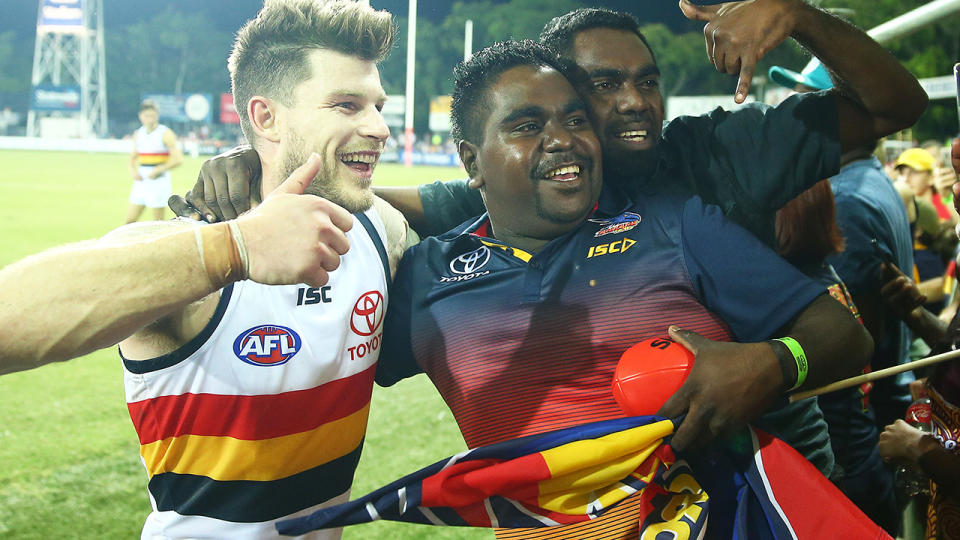 Adelaide Crows player Bryce Gibbs is pictured with fans after a 2019 AFL match.