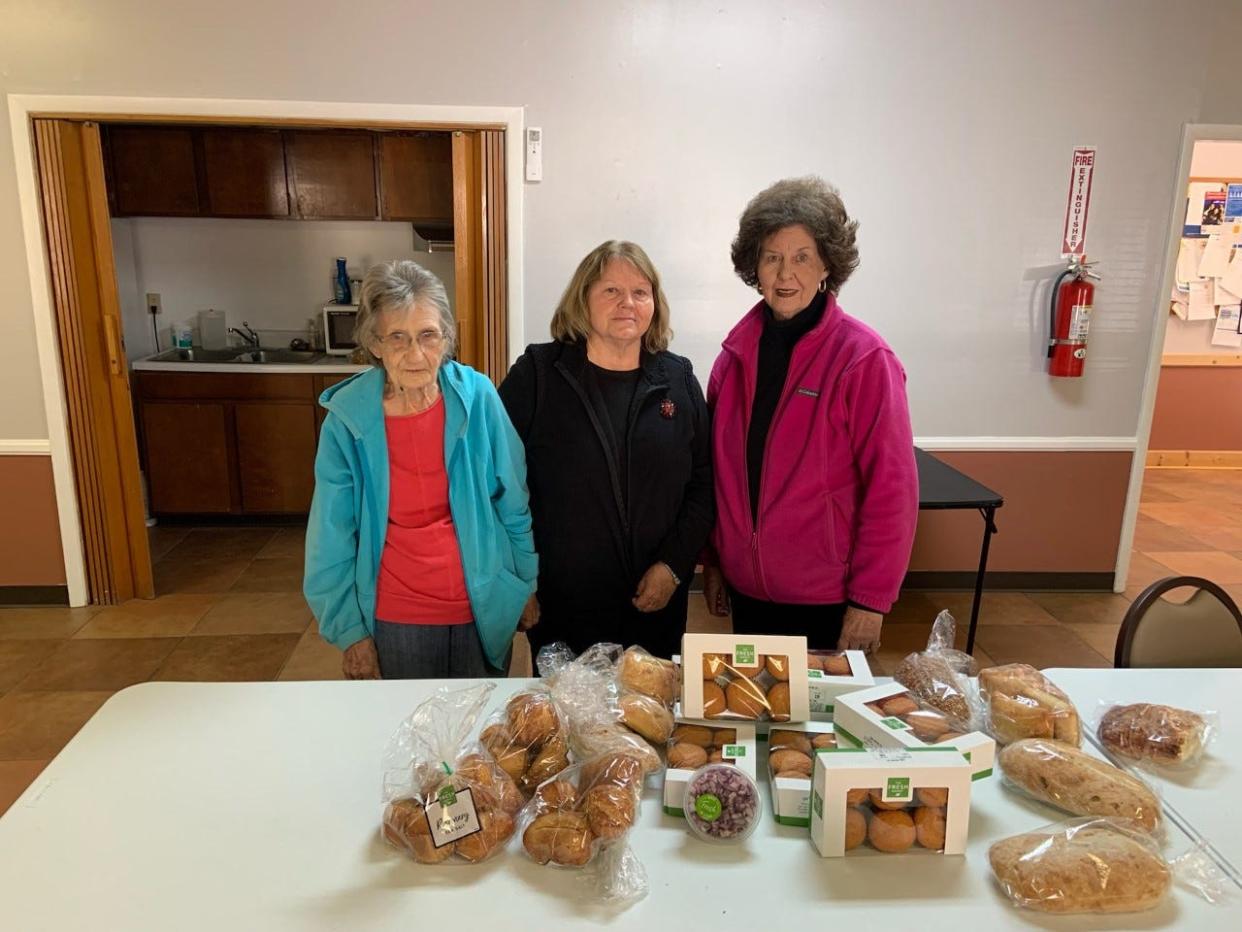 Elizabeth Hamrick, right, poses at the Marshall Housing Authority with executive director Linda Payne, center, and a longtime client, Johnie.  Hamrick was recognized with the National Society of the Daughters of American Revolution's "Excellence in Community Service" award Dec. 13.