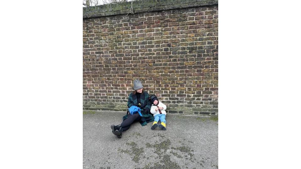 A photo of Princess Eugenie and her son August sitting on the floor outside