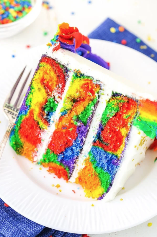 <p>This rainbow swirl cake is made with three layers of homemade rainbow cake, then decorated with rainbow swirl frosting around the edges! It’s a moist, delicious cake that’s easy to make and perfect for a celebration!</p><p><strong>Get the recipe: <a href="https://www.lifeloveandsugar.com/rainbow-swirl-cake/" rel="nofollow noopener" target="_blank" data-ylk="slk:Rainbow Swirl Cake;elm:context_link;itc:0;sec:content-canvas" class="link "><em>Rainbow Swirl Cake</em></a></strong></p>