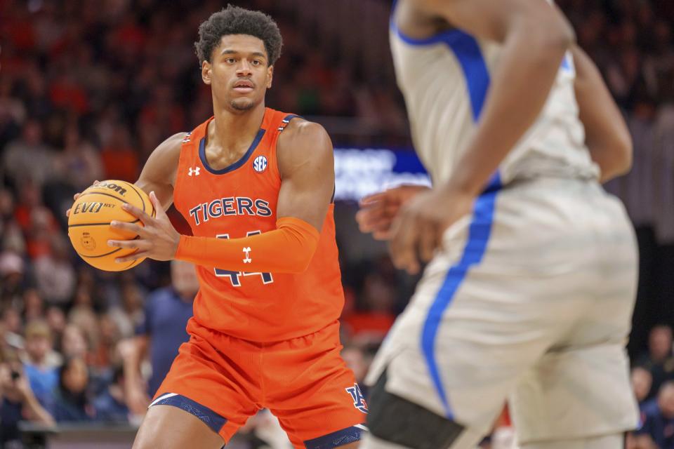 Auburn center Dylan Cardwell (44) attempts a pass against a Memphis defender during the first half of an NCAA college basketball game on Saturday, Dec. 10, 2022, in Atlanta, Ga. (AP Photo/Erik Rank)