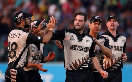 Cricket - Australia v New Zealand - World Twenty20 cricket tournament - Dharamsala, India, 18/03/2016. New Zealand's Mitchell McClenaghan (3rd R) is congratulated by his teammates after taking the wicket of Australia's Mitchell Marsh. REUTERS/Adnan Abidi