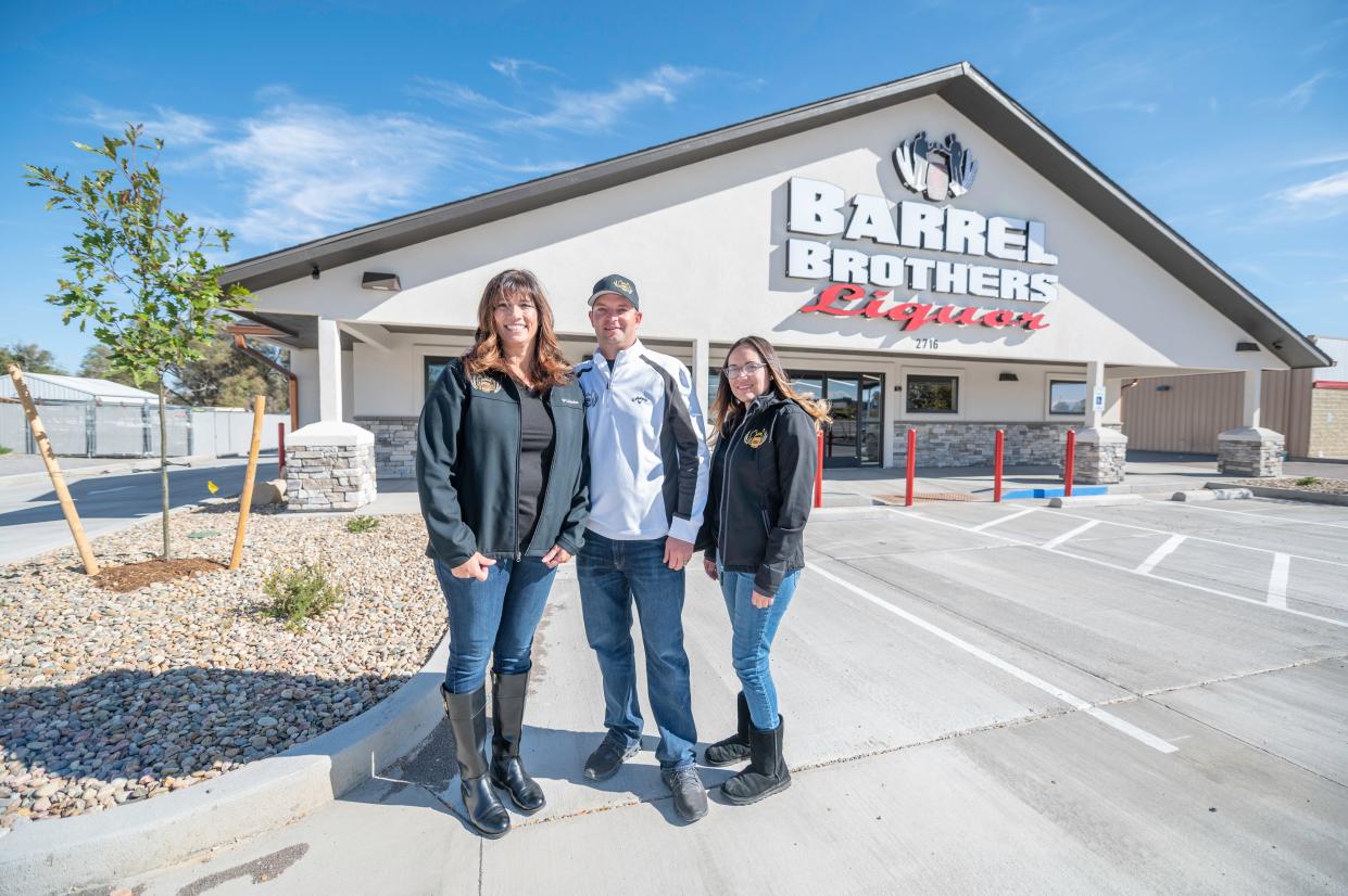 Owners of Barrel Brothers Liquor Kylie Felzien, left, Adam Felzien and longtime employee Alicia Romero, right, stand outside the store's new location at 2716 S Prairie Ave. on Friday, October 27, 2023.