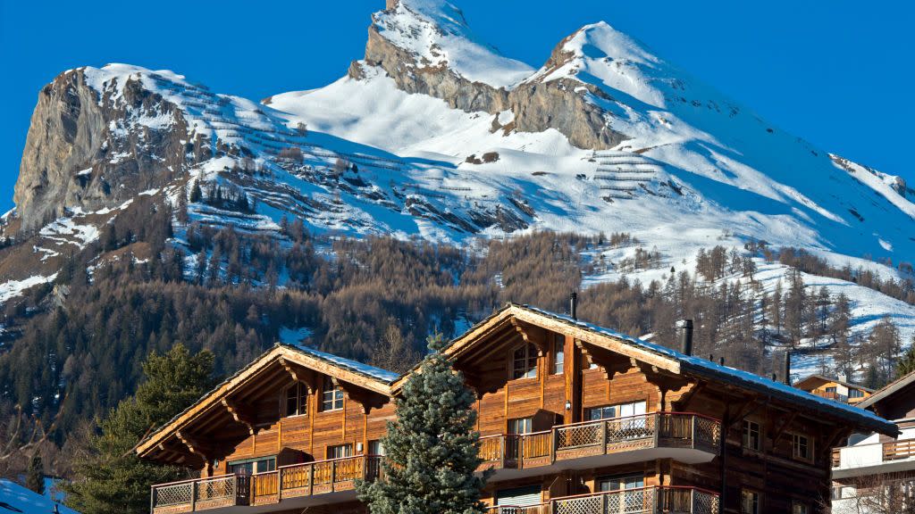 swiss chalets and holiday homes below the snow capped pointe de chemo peak, ovronnaz, valais, switzerland