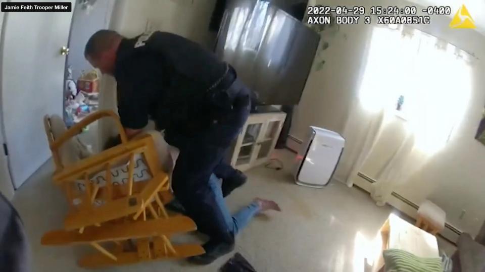 Hyde Park police Officer Joshua Kemlage wrestles Jamie Feith to the ground and tries to get a knife away from her during a domestic violence call at her home April 29, 2022. Moments later, after she managed to get up and move to the kitchen still with the knife, Kemlage fatally shot her. This is a screen grab from body-worn camera video of state Trooper Christopher Miller that was released by the New York State Attorney General's Office. An investigation into the shooting is ongoing by the AG's Office of Special Investigation.