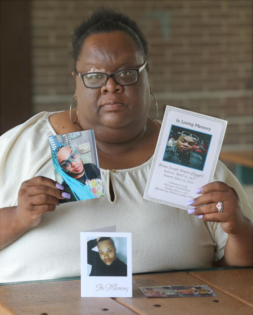 Vivian Powers-Smith shows photos of her brother Brian "Egypt" Powers in Akron.