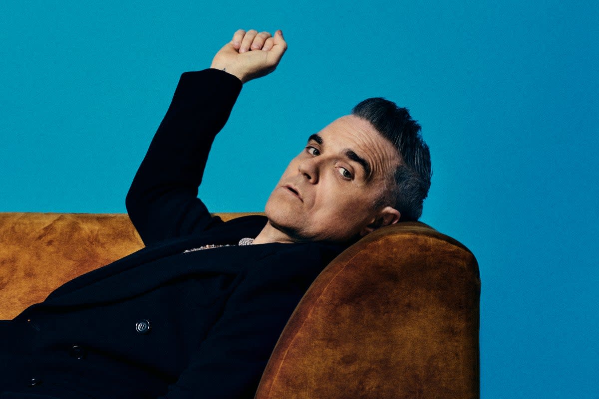 Analyse That: Robbie Williams poses on a couch in a promotional photo for his new Netflix docuseries (Netflix)