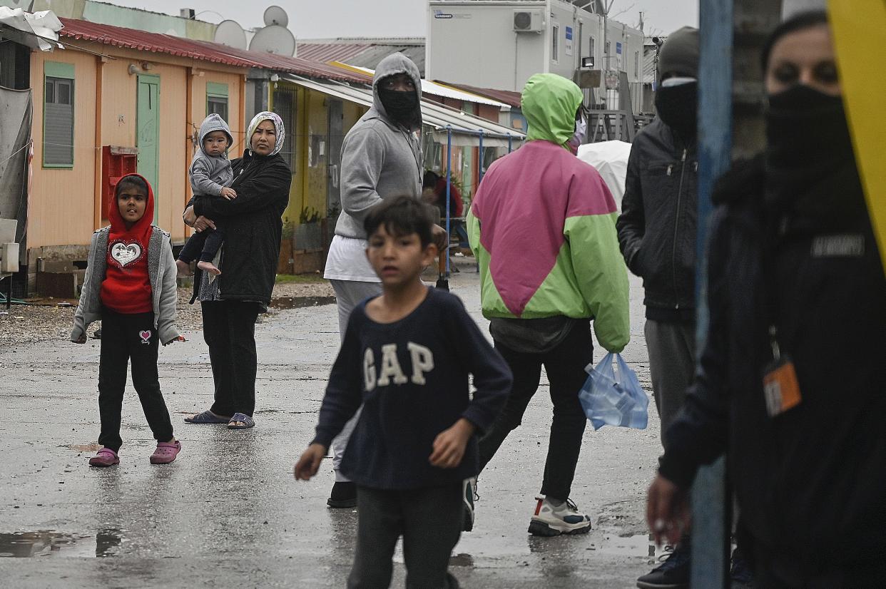 Refugees look on from the Eleonas camp during a demonstration by solidarity groups calling for enrolment of all the refugee children to public schools and equal rights to education.in Athens on February 14, 2021. - Amid the lockdown in the country which affects the refugee camps, only some 5000 refugee children from 31,000 living in Greece attend schools or online education, according to KEERFA (Movement United Against Racism). (Photo by LOUISA GOULIAMAKI / AFP) (Photo by LOUISA GOULIAMAKI/AFP via Getty Images)