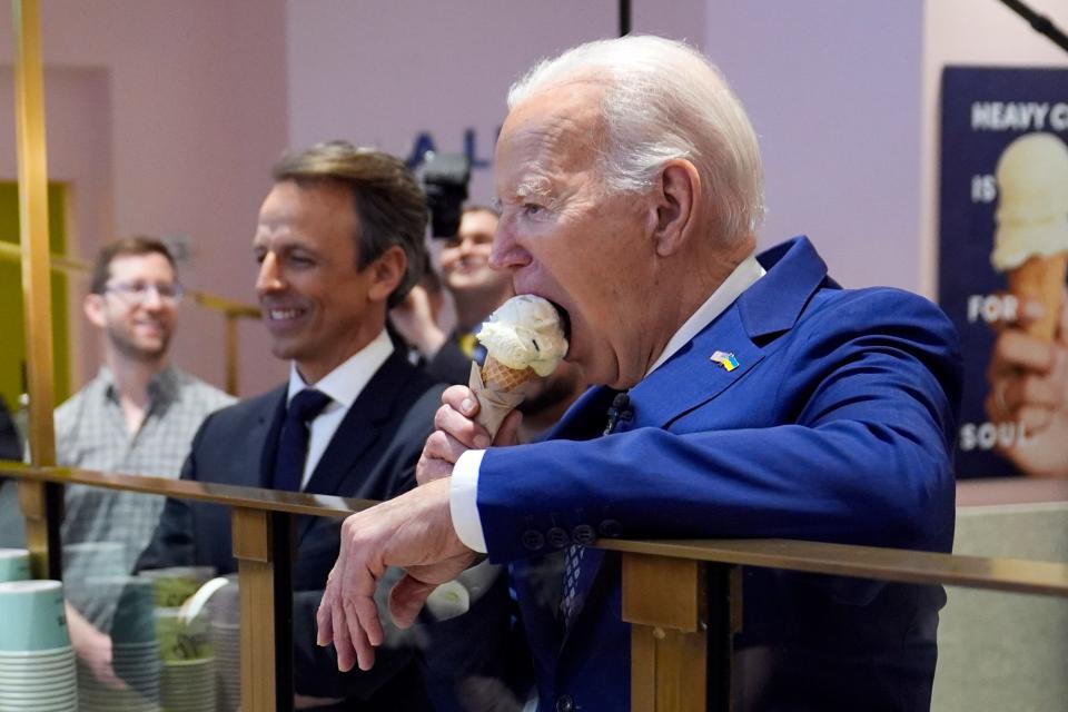 President Joe Biden eats ice cream at Van Leeuwen Ice Cream Monday, Feb. 26, 2024, in New York, as Seth Meyers watches. (AP Photo/Evan Vucci)