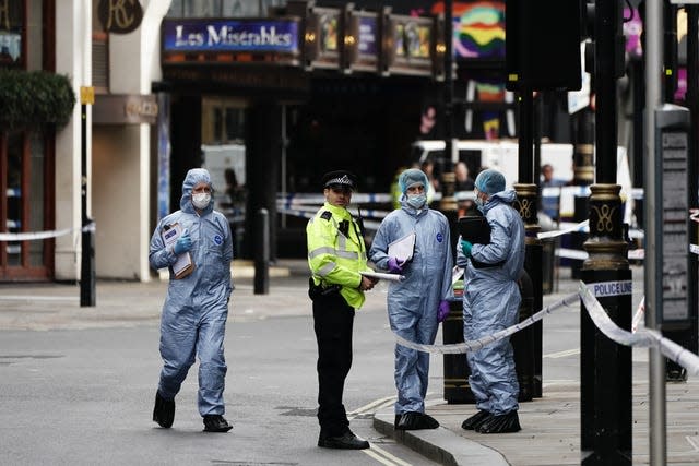 Forensics officers and police at the scene in Shaftesbury Avenue, central London (Aaron Chow/PA)