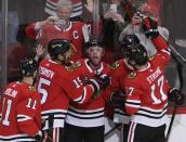 Feb 7, 2019; Chicago, IL, USA; Chicago Blackhawks center Jonathan Toews (center) celebrates his game winning goal against the Vancouver Canucks with his teammates during the overtime at United Center. Mandatory Credit: David Banks-USA TODAY Sports