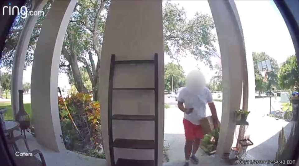 An Amazon delivery man approaches a home in Florida with a package moments before he rides away on a bicycle belonging to a little girl at the home.