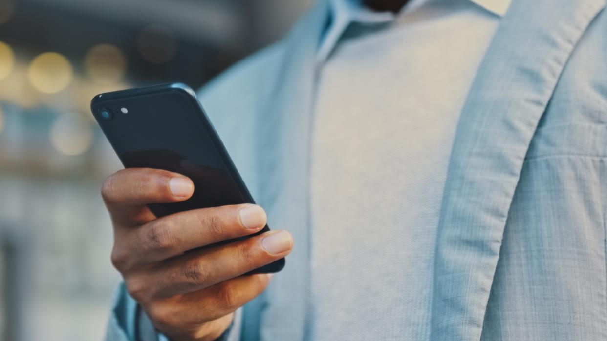  Man holding cellphone. 