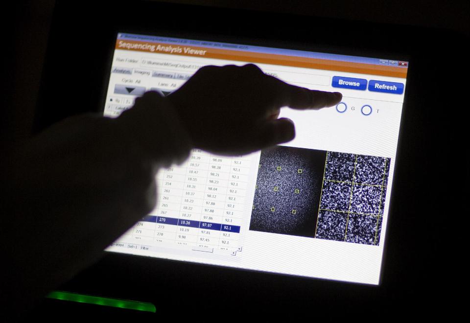 This photo taken Nov. 25, 2013 shows microbiologist Heather Carleton pulling up results of Listeria bacteria DNA while demonstrating a whole-genome sequencing machine called a MiSeq in a foodborne disease outbreak lab at the federal Centers for Disease Control and Prevention in Atlanta. The nation's disease detectives are beginning a program to try to outsmart outbreaks by routinely decoding the DNA of deadly bacteria and viruses. The initial target: Listeria, a kind of bacteria that's the third-leading cause of death from food poisoning, and one that's especially dangerous to pregnant women. Already, the technology has helped to solve a small listeria outbreak that killed one person in California and sickened seven others in Maryland.(AP Photo/David Goldman)