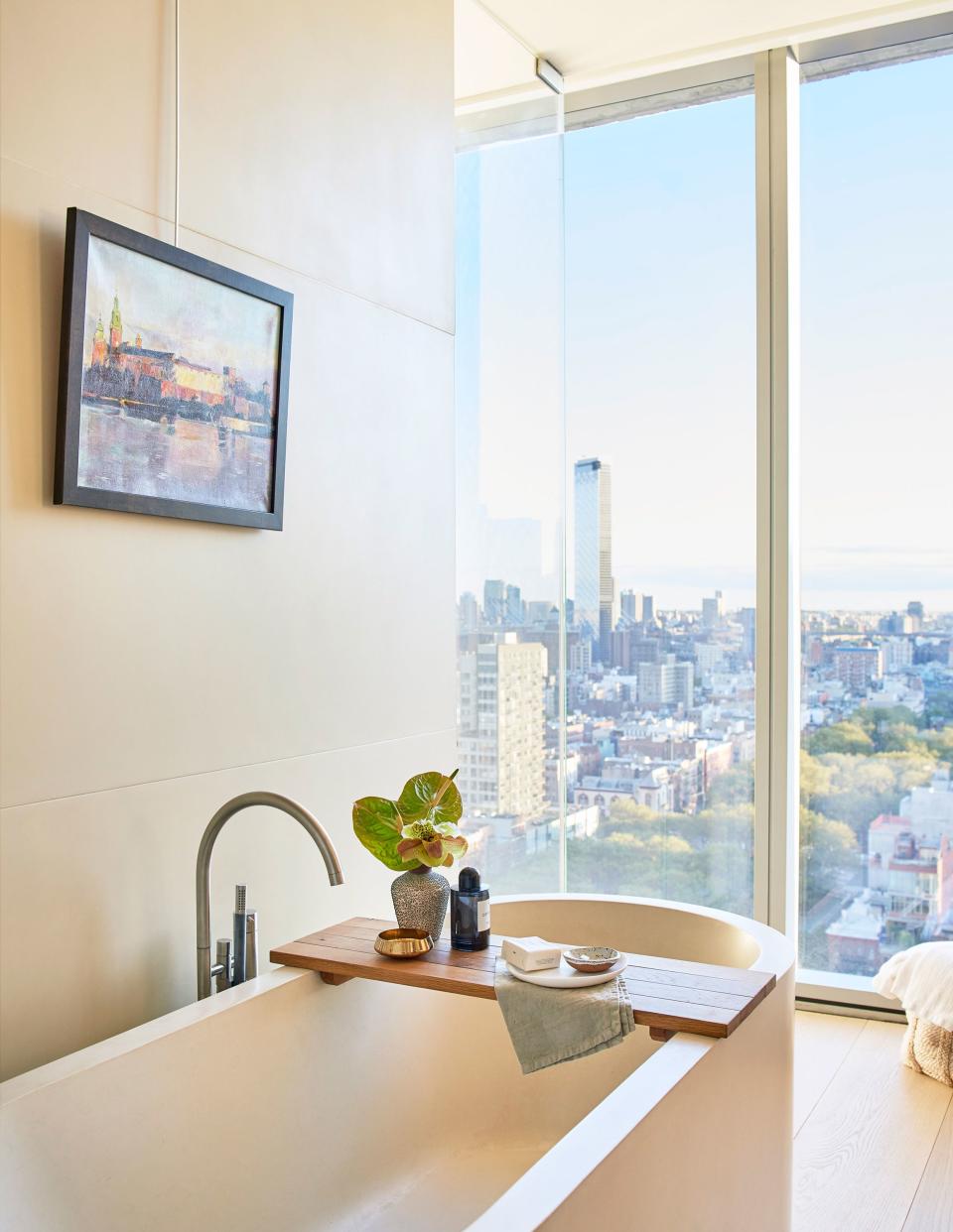 In the master bath, the deep tub is decorated with accessories from Côte à Coast and Homenature in New York. Above it hangs a landscape painting from Ostrego’s birthplace, Krakow, purchased by his father at Florian’s Gate. “It’s a reminder of the sacrifices my parents made to be here in the U.S.,” he says.