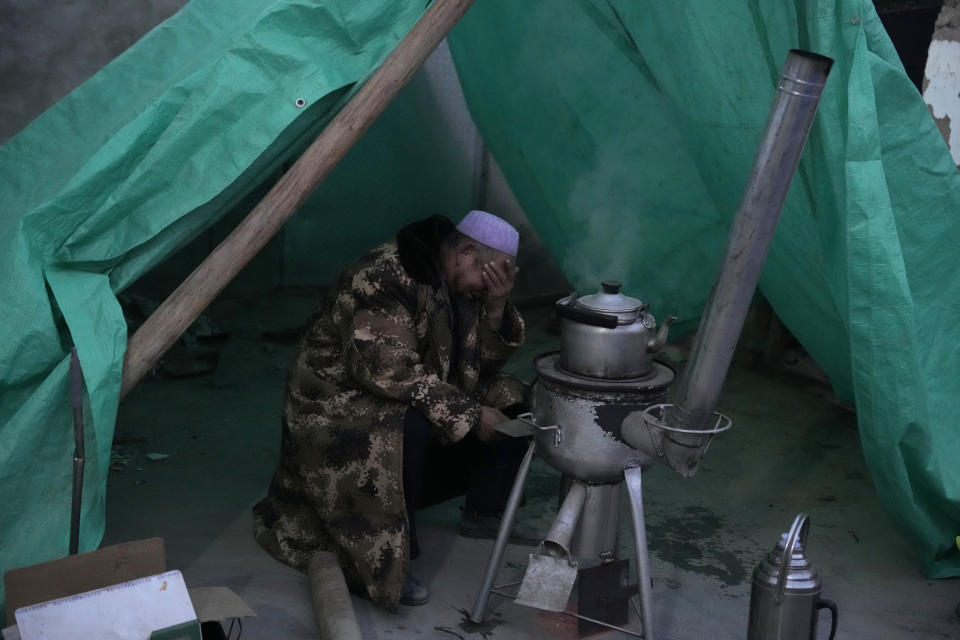 Ma Chengyun grieves for his daughter-in-law who died in the earthquake in Yangwa village near Dahejia town in northwestern China's Gansu province, Wednesday, Dec. 20, 2023. A strong overnight earthquake rattled a mountainous region of northwestern China, authorities said Tuesday, destroying homes, leaving residents out in a below-freezing winter night and killing many in the nation's deadliest quake in nine years. (AP Photo/Ng Han Guan)