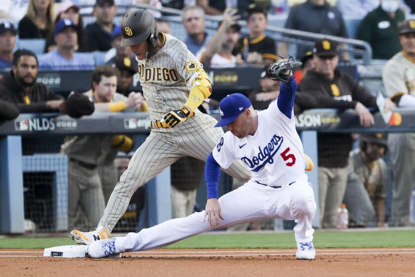 Los Angeles, CA - October 12: Los Angeles Dodgers first baseman Freddie Freeman, right, forces out San Diego Padres'  Ha-Seong Kim at first base during the first inning in game two of the NLDS at Dodger Stadium on Wednesday, Oct.  12, 2022 in Los Angeles, CA. (Gina Ferazzi / Los Angeles Times)
