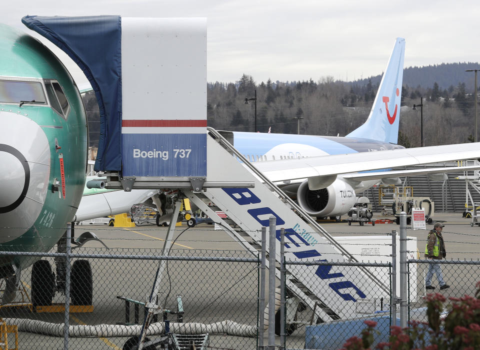 In this Monday, March 11, 2019 file photo, a Boeing 737 MAX 8 airplane being built for TUI Group sits parked in the background at right at Boeing Co.'s Renton Assembly Plant in Renton, Wash. The Transportation Department confirmed that its watchdog agency will examine how the FAA certified the Boeing 737 Max 8 aircraft, the now-grounded plane involved in two fatal accidents within five months. The FAA had stood by the safety of the plane up until last Wednesday, March 13, 2019 despite other countries grounding it. (AP Photo/Ted S. Warren, File)