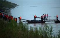 Chinese rescue workers carry a body from the capsized passenger ship Dongfangzhixing which sank in the Yangtze river in Hubei province on June 2, 2015