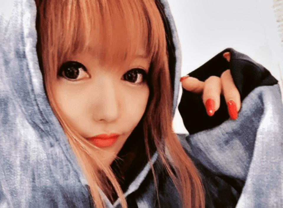 Marisa Nakagawa wears a hoodie as she poses for a close-up selfie. 