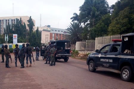 Members of security forces stand guard outside a court that is set to rule on Shi'ite leader Zakzaky's bail application, in Kaduna