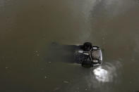 A vehicle is seen floating on the sea after Typhoon Hato hits Macau, China August 24,2017 REUTERS/Tyrone Siu