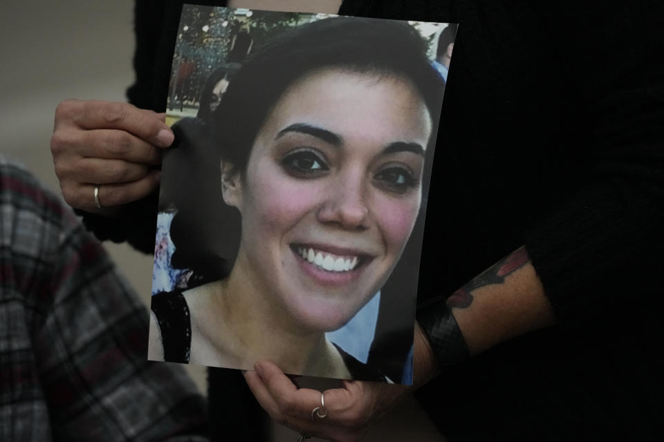 A family picture of Alexandra "Allie" Kurtz, the 26-year-old crew member, galley cook and victim of the Sept. 2, 2019 fire aboard the dive boat, Conception, at Santa Cruz Island, is held by a family member arriving at federal court in Los Angeles, Wednesday, Oct. 25, 2023. Federal prosecutors are seeking justice for 34 people killed in a fire aboard a scuba dive boat called the Conception in 2019. The trial against Capt. Jerry Boylan began Tuesday with jury selection. (AP Photo/Damian Dovarganes)