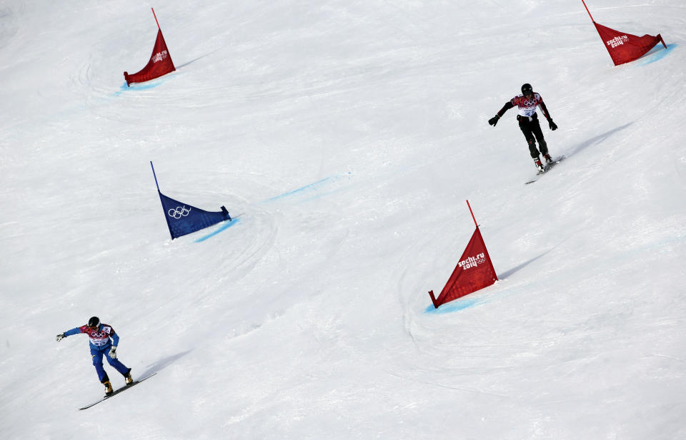 Ukraine's Yosyf Penyak, left, competes against Bulgaria's Radoslav Yankov during men's snowboard parallel giant slalom qualifying at the Rosa Khutor Extreme Park, at the 2014 Winter Olympics, Wednesday, Feb. 19, 2014, in Krasnaya Polyana, Russia. (AP Photo/Andy Wong)