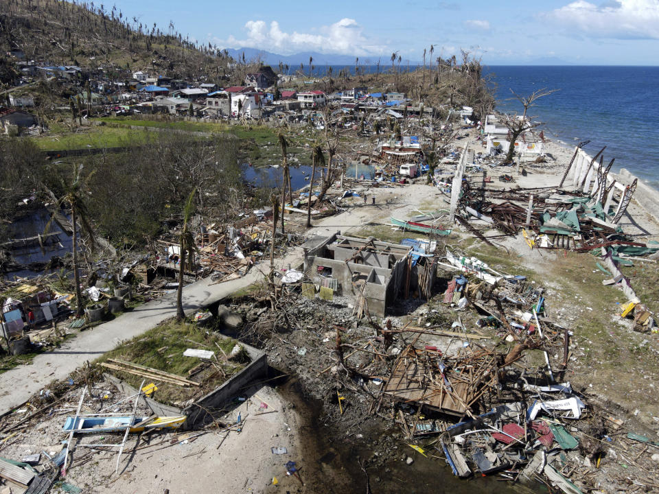 In this photo provided by Greenpeace, damaged homes due to Typhoon Rai lie along a coastal village in Surigao City, southern Philippines Monday Dec. 20, 2021. The governor of a central Philippine province devastated by Typhoon Rai last week pleaded on radio Tuesday for the government to quickly send food and other aid, warning that without outside help, army troops and police forces would have to be deployed to prevent looting amid growing hunger. (Erwin Mascarinas/Greenpeace via AP)