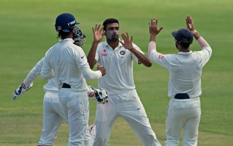 India's cricketer Ravichandran Ashwin (C) celebrates during day four of the test match against the West Indies on July 24, 2016