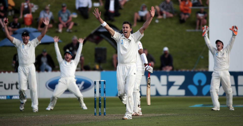 New Zealand's Trent Boult gets the wicket of India's Cheteshwar Pujara (C, obscured) during the first innings on day one of the second international test cricket match at the Basin Reserve in Wellington, February 14, 2014.