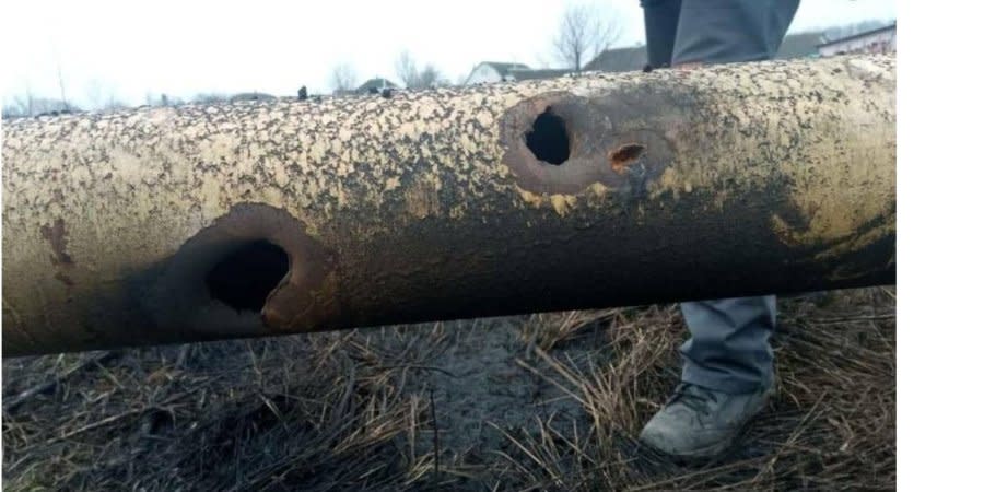 A gas pipe bears shrapnel holes from Russian shelling