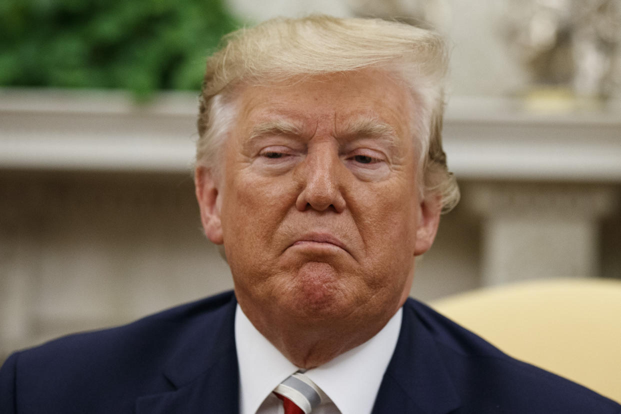 President Donald Trump pauses while speaking during a meeting with Romanian President Klaus Iohannis in the Oval Office of the White House, Tuesday, Aug. 20, 2019, in Washington. (AP Photo/Alex Brandon)