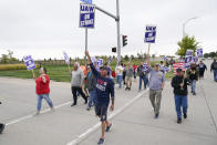 Members of the United Auto Workers strike outside of a John Deere plant, Wednesday, Oct. 20, 2021, in Ankeny, Iowa. About 10,000 UAW workers have gone on strike against John Deere since last Thursday at plants in Iowa, Illinois and Kansas. (AP Photo/Charlie Neibergall)