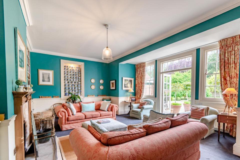 Eastern Daily Press: The south-facing living room with French doors leading out to the terrace and walled garden